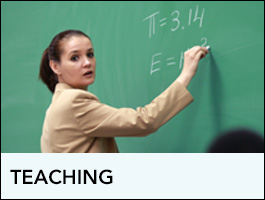 Teacher writing on a chalkboard