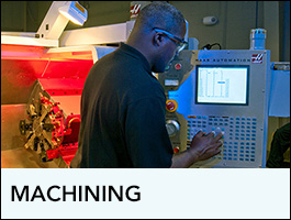 Programs Machining showing a CNC operator using equipment