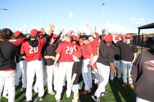 Baseball team huddled after a game.